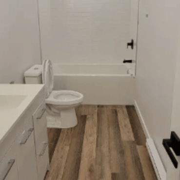 Freshly cleaned bathroom with sink, bathtub and toilet