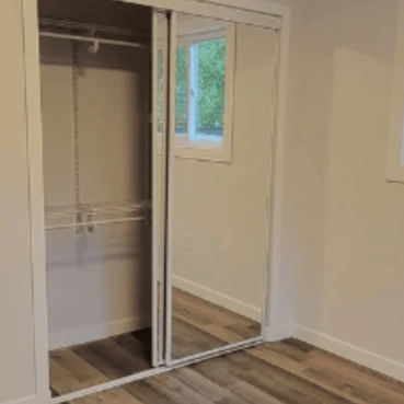 Empty closet in a bedroom with mirror