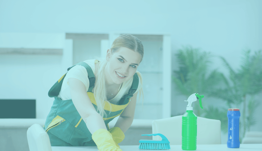 Female house cleaner wearing gloves cleaning table